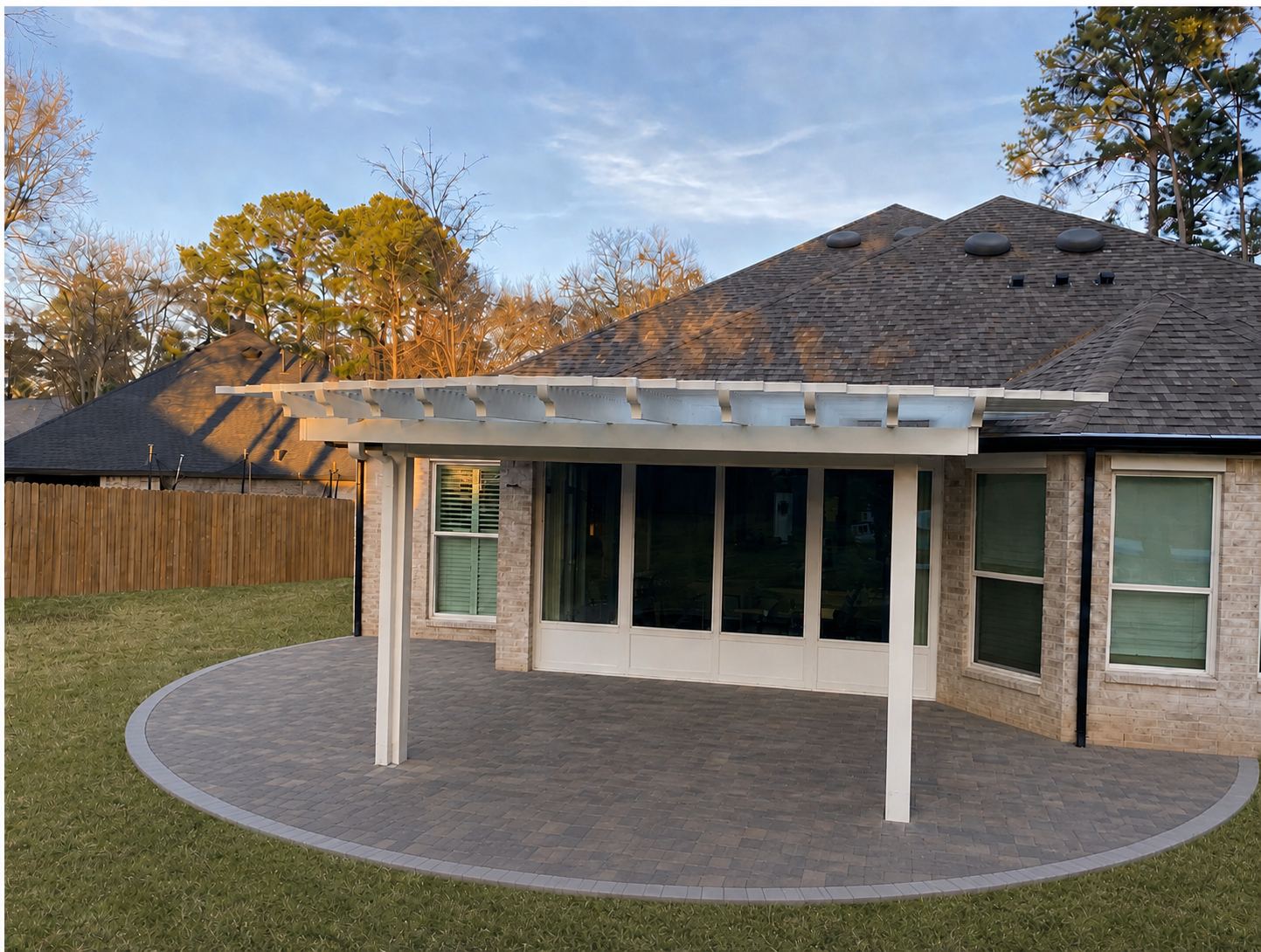 Straight-on view of the hybrid cover — solid section over the windows, lattice out front, oval paver patio below