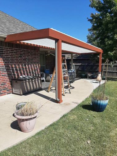 Wood-beam insulated patio cover overlooking pond