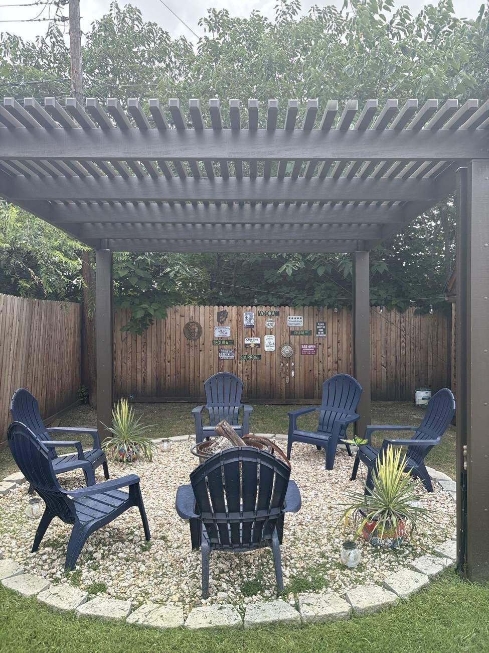 Wood pergola over fire pit seating